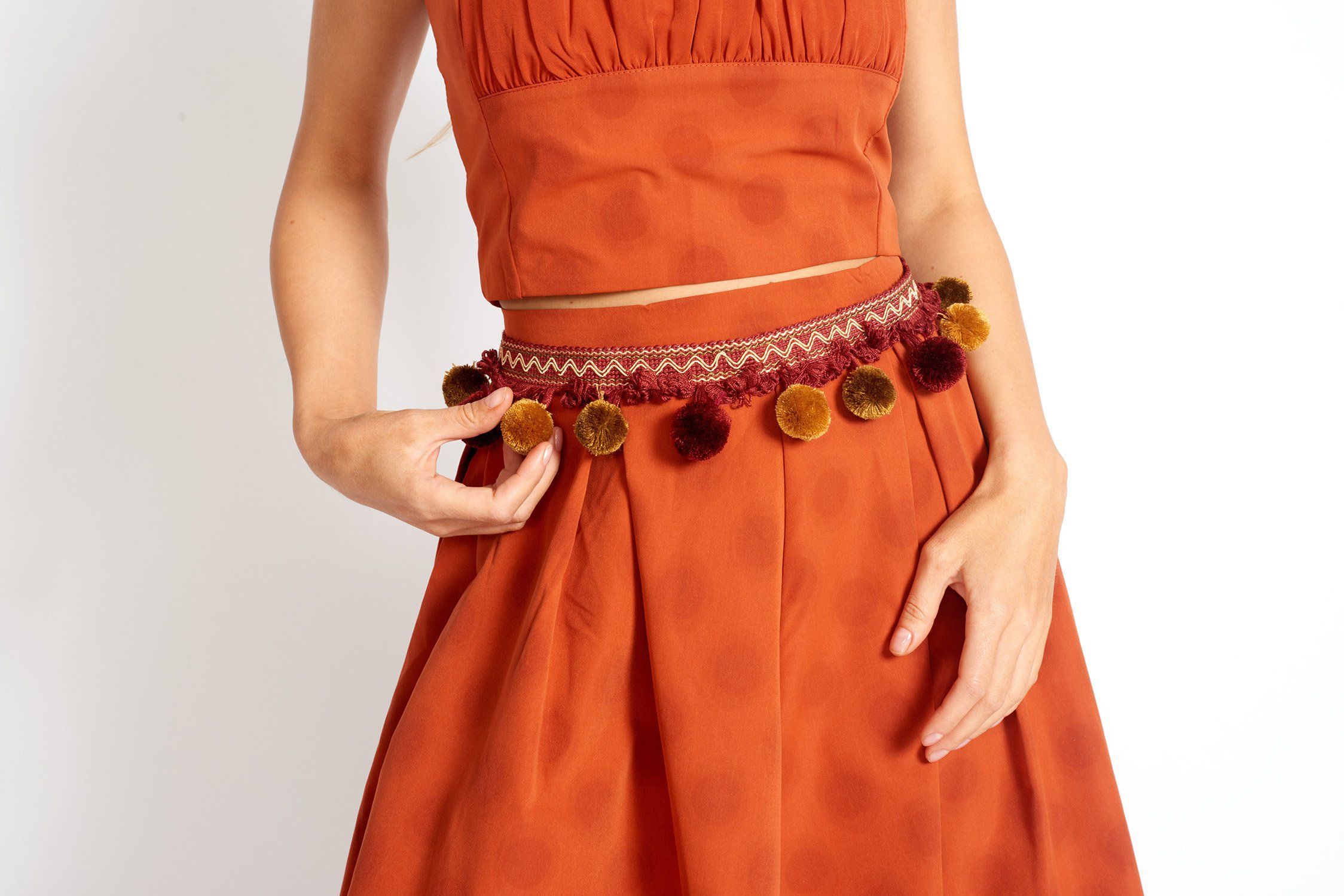 Tulum Vibe Bohemian Pom Pom Belt featuring colorful tassels and adjustable tie closure, perfect for a bohemian look.