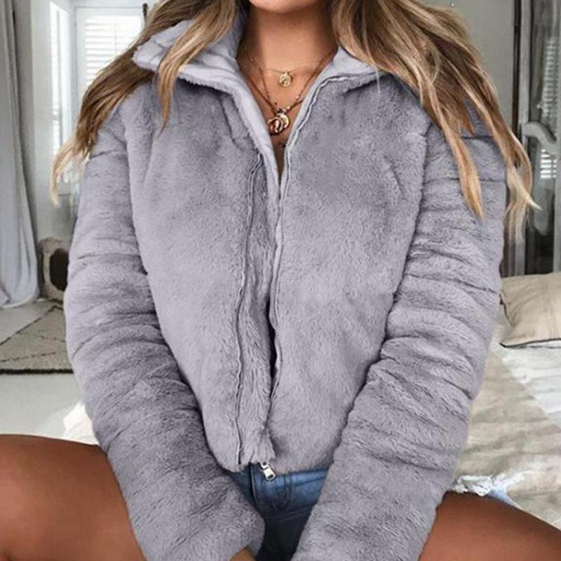 A stylish women's faux fur jacket with a turndown collar, featuring a zipper closure and long sleeves, perfect for winter streetwear.