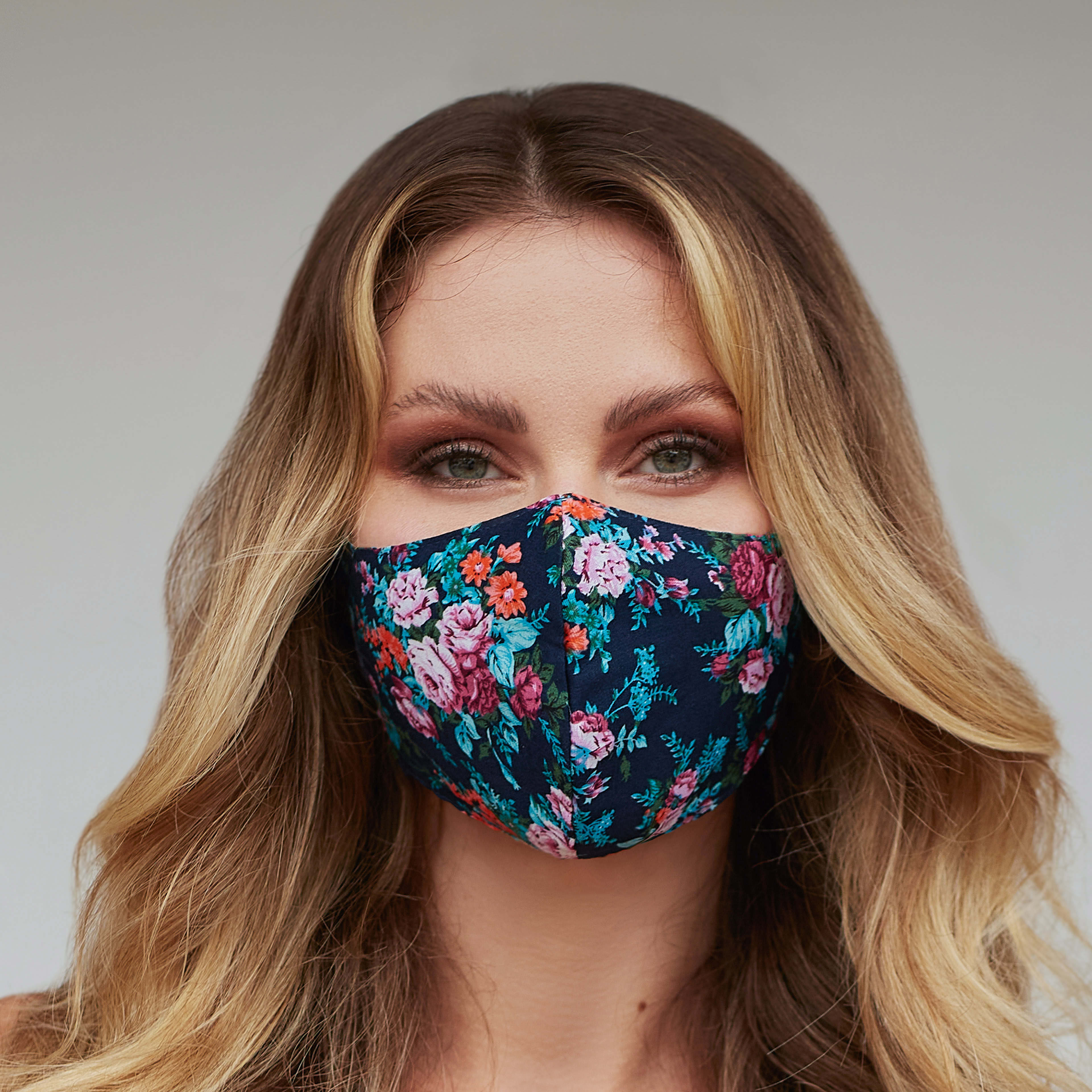 Turquoise floral face mask featuring a vibrant floral pattern, designed for comfort and style, suitable for various activities.