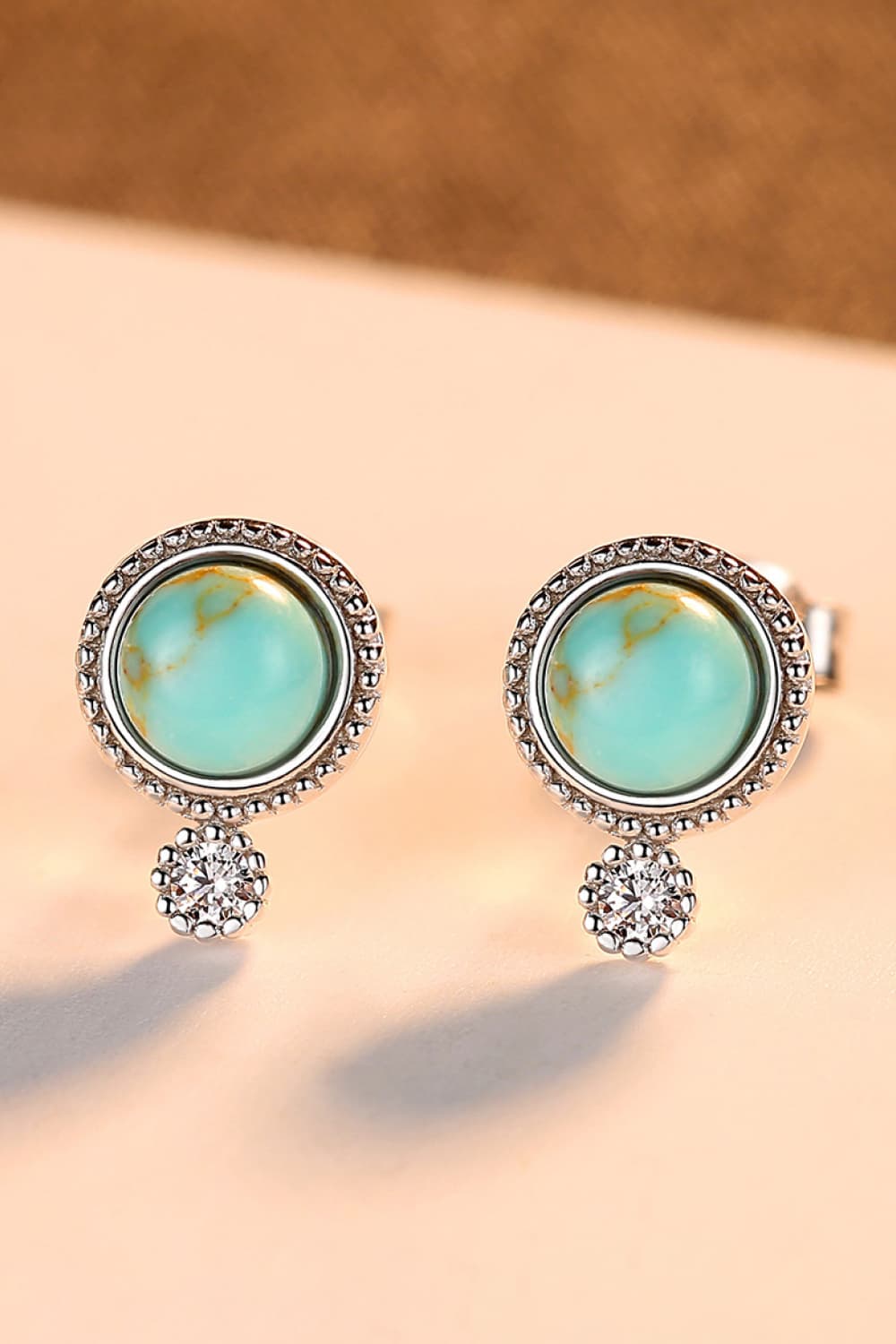 Elegant turquoise earrings with platinum plating and zircon accents, displayed in a matching gift box.