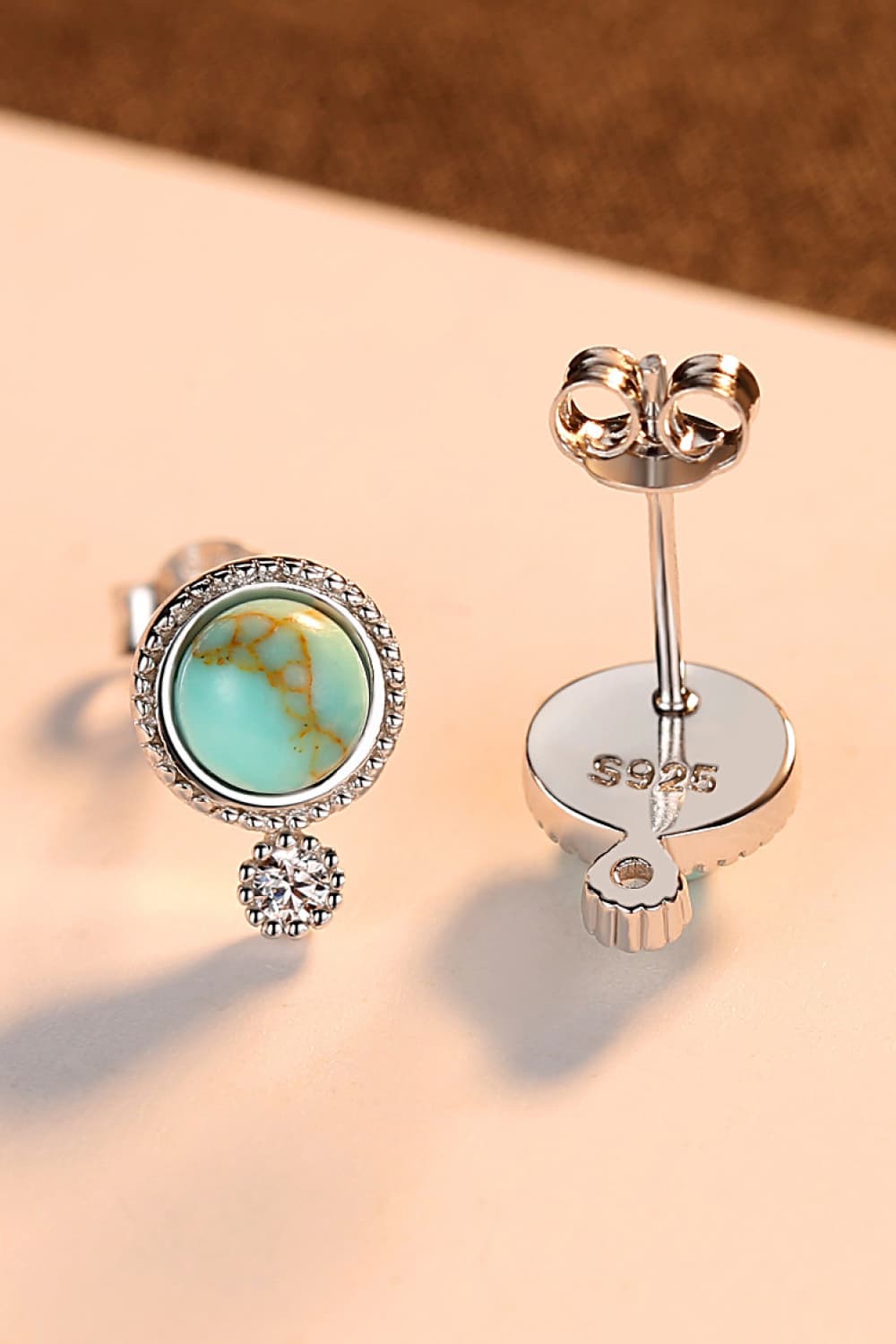 Elegant turquoise earrings with platinum plating and zircon accents, displayed in a matching gift box.