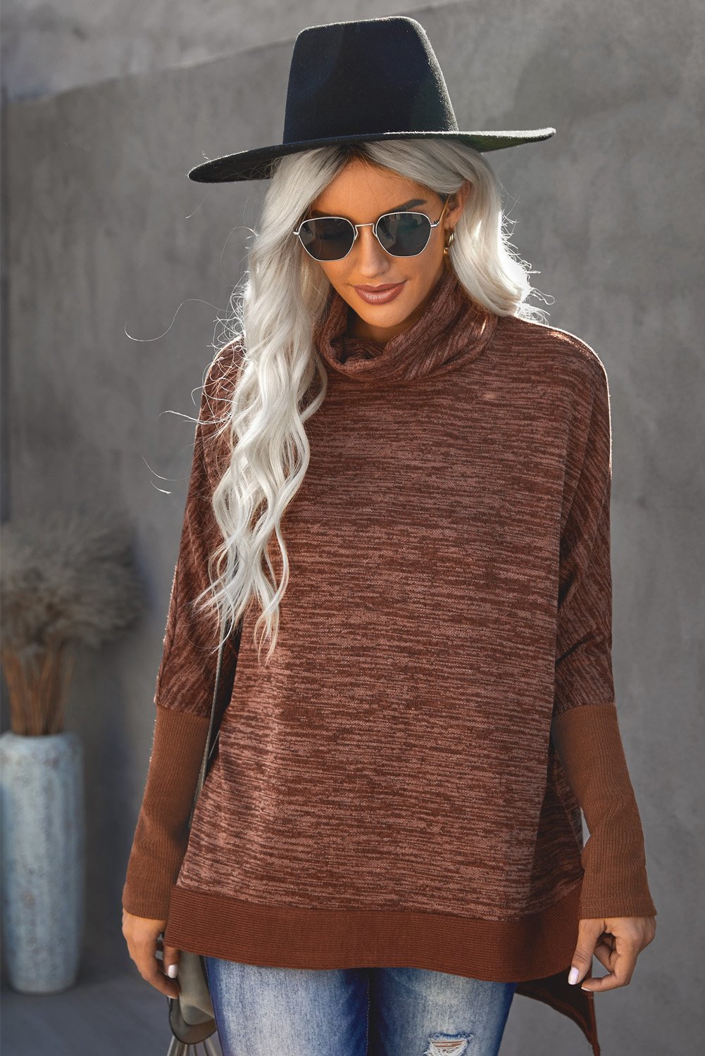 A stylish Turtleneck Bat Sleeve Side Slit Tunic Top in a cozy fabric, featuring a turtleneck, bat sleeves, and elegant side slits.