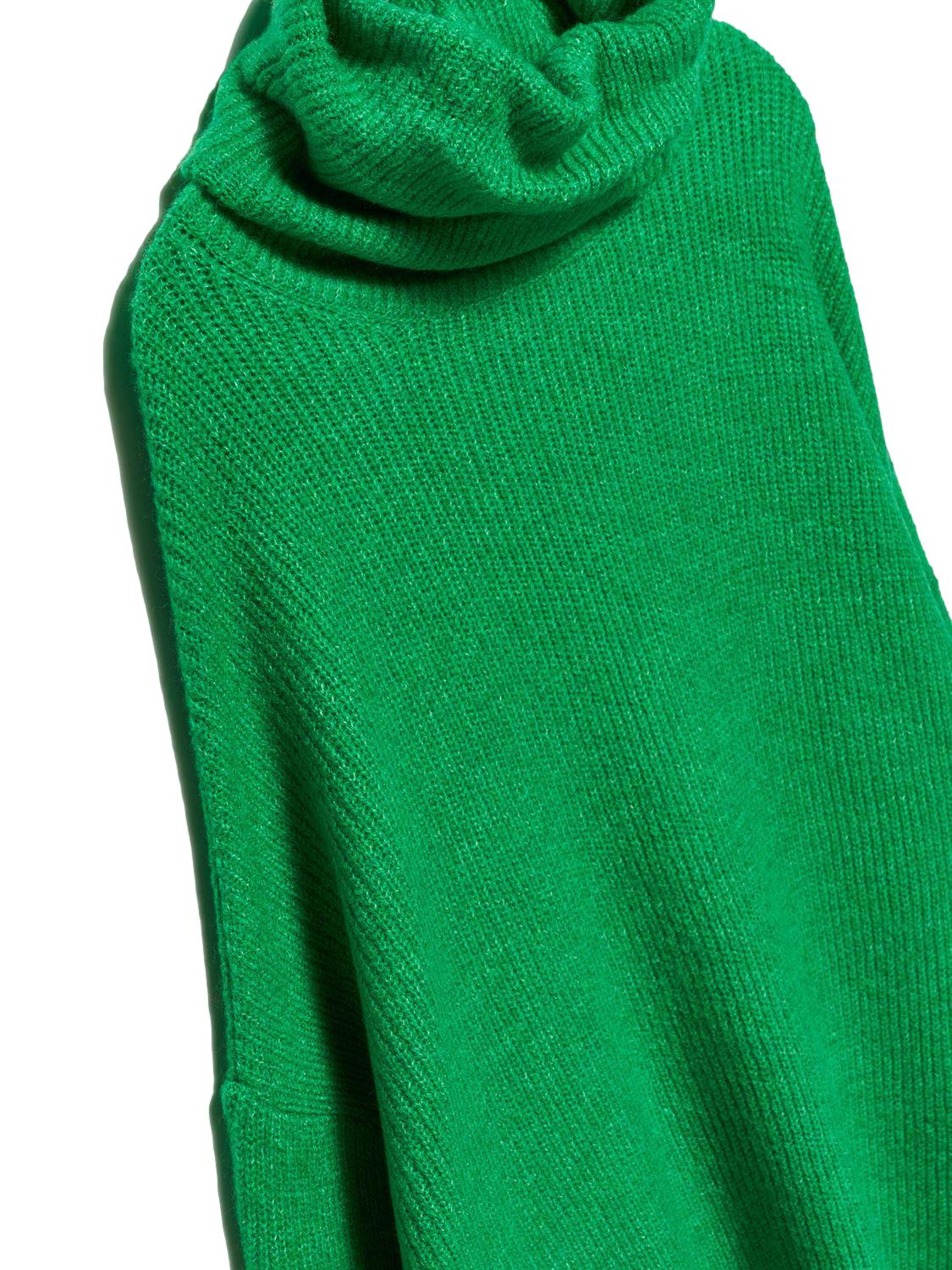 A cozy Turtleneck Wide Sweater in a soft acrylic-polyester blend, featuring a relaxed fit and stylish turtleneck design.