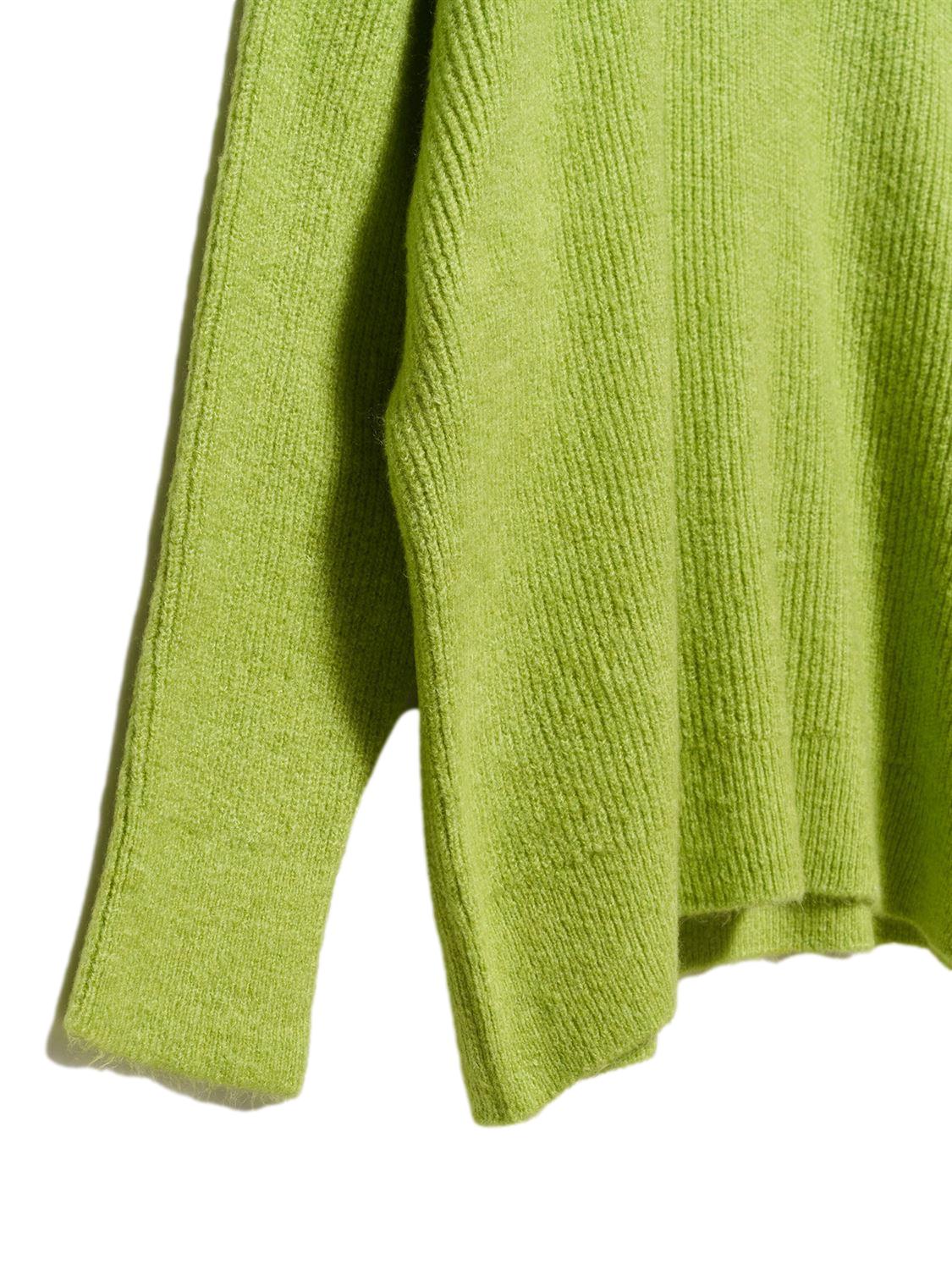 A cozy Turtleneck Wide Sweater in a soft acrylic-polyester blend, featuring a relaxed fit and stylish turtleneck design.