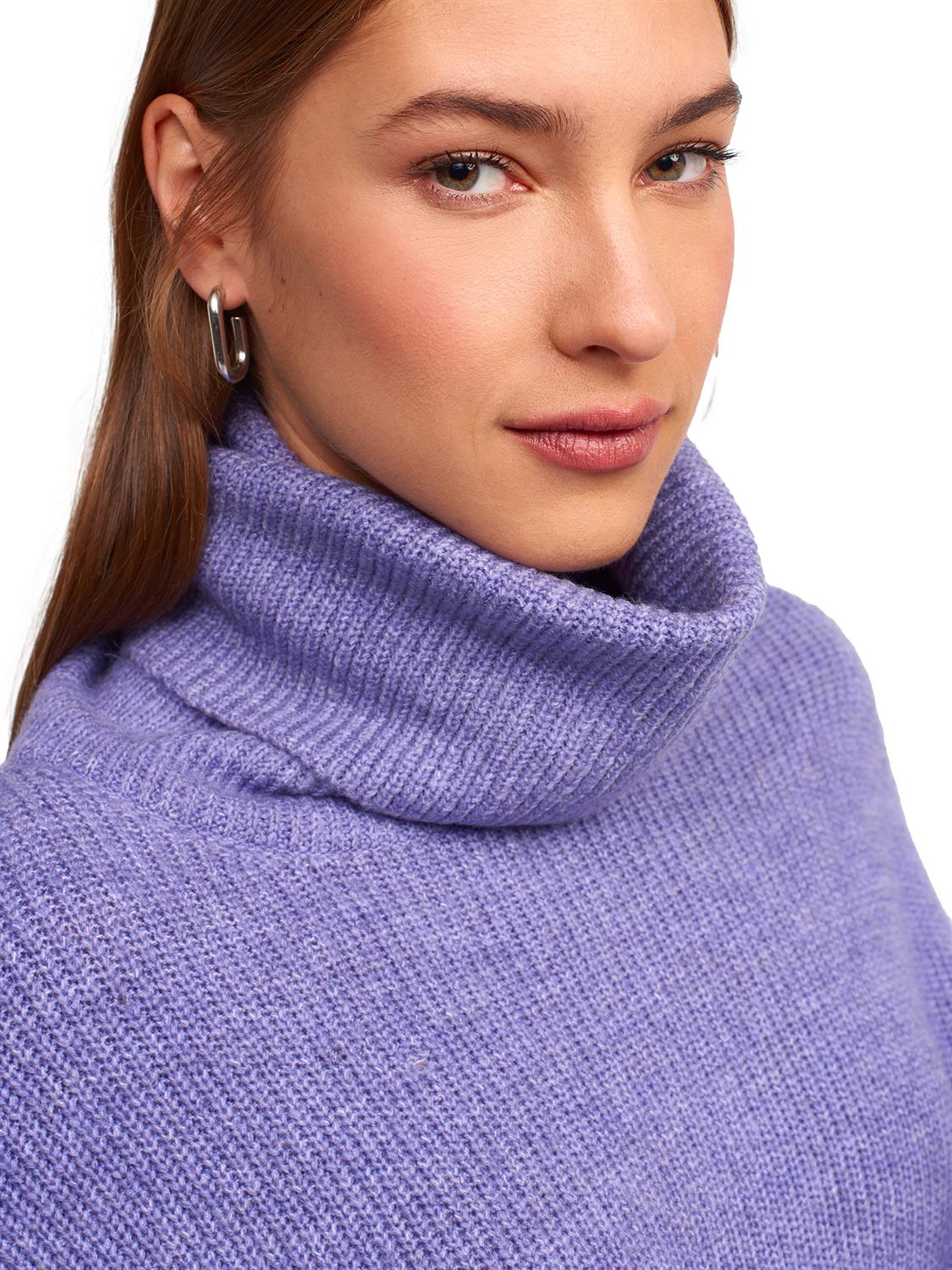 A cozy Turtleneck Wide Sweater in a soft acrylic-polyester blend, featuring a relaxed fit and stylish turtleneck design.