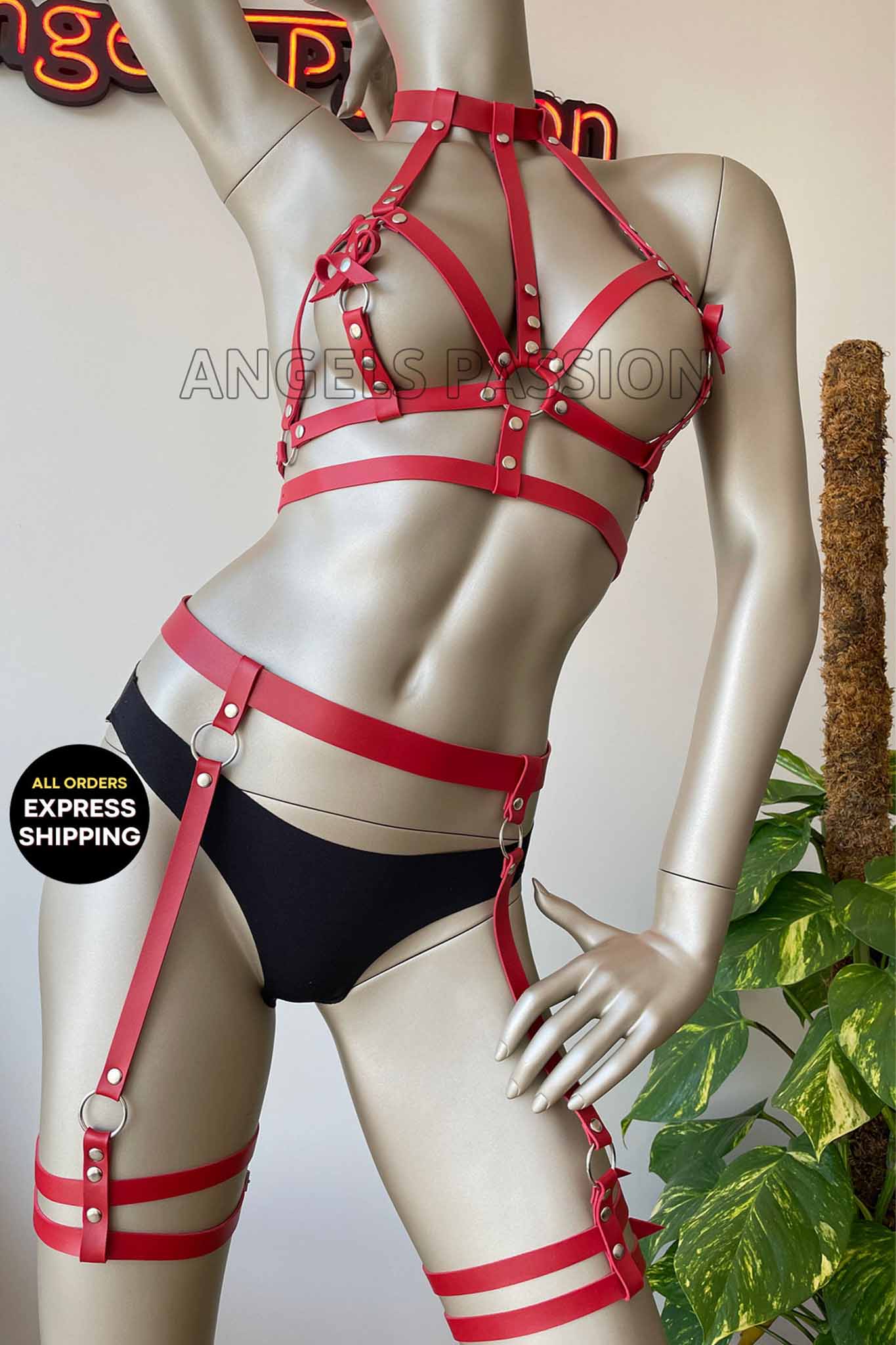 A stylish red leather body harness designed for ladies, featuring a laced-up design that enhances the silhouette.