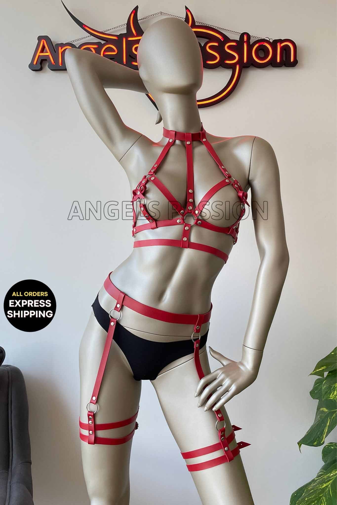 A stylish red leather body harness designed for ladies, featuring a laced-up design that enhances the silhouette.