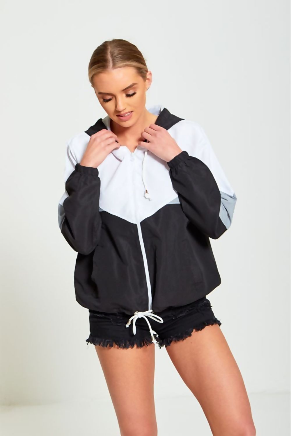 A stylish black two-tone cagoule jacket for women, featuring a modern design and comfortable fit, perfect for casual outings.