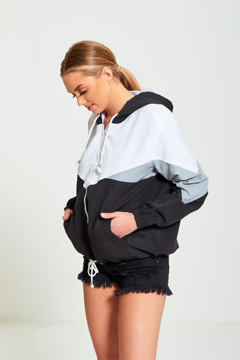 A stylish black two-tone cagoule jacket for women, featuring a modern design and comfortable fit, perfect for casual outings.