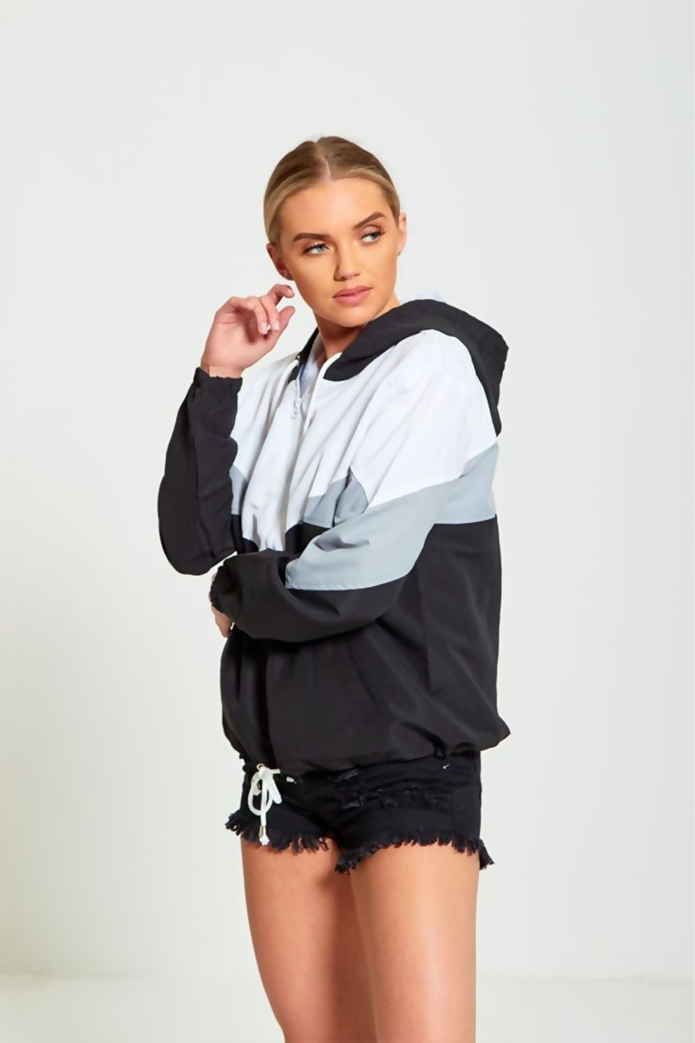 A stylish black two-tone cagoule jacket for women, featuring a modern design and comfortable fit, perfect for casual outings.