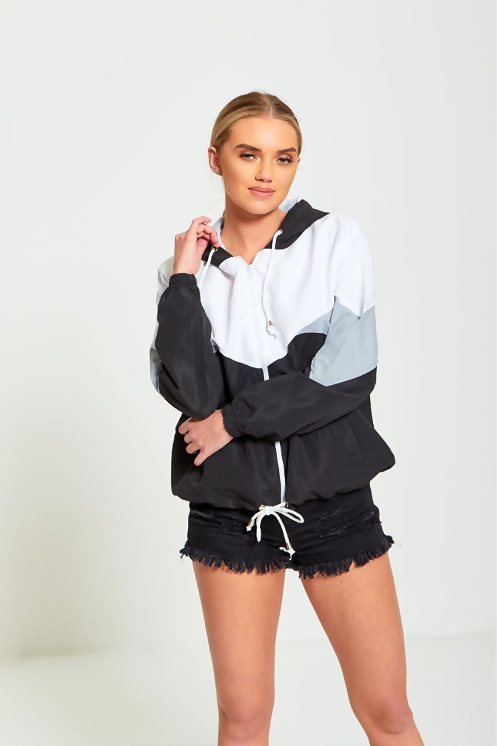 A stylish black two-tone cagoule jacket for women, featuring a modern design and comfortable fit, perfect for casual outings.