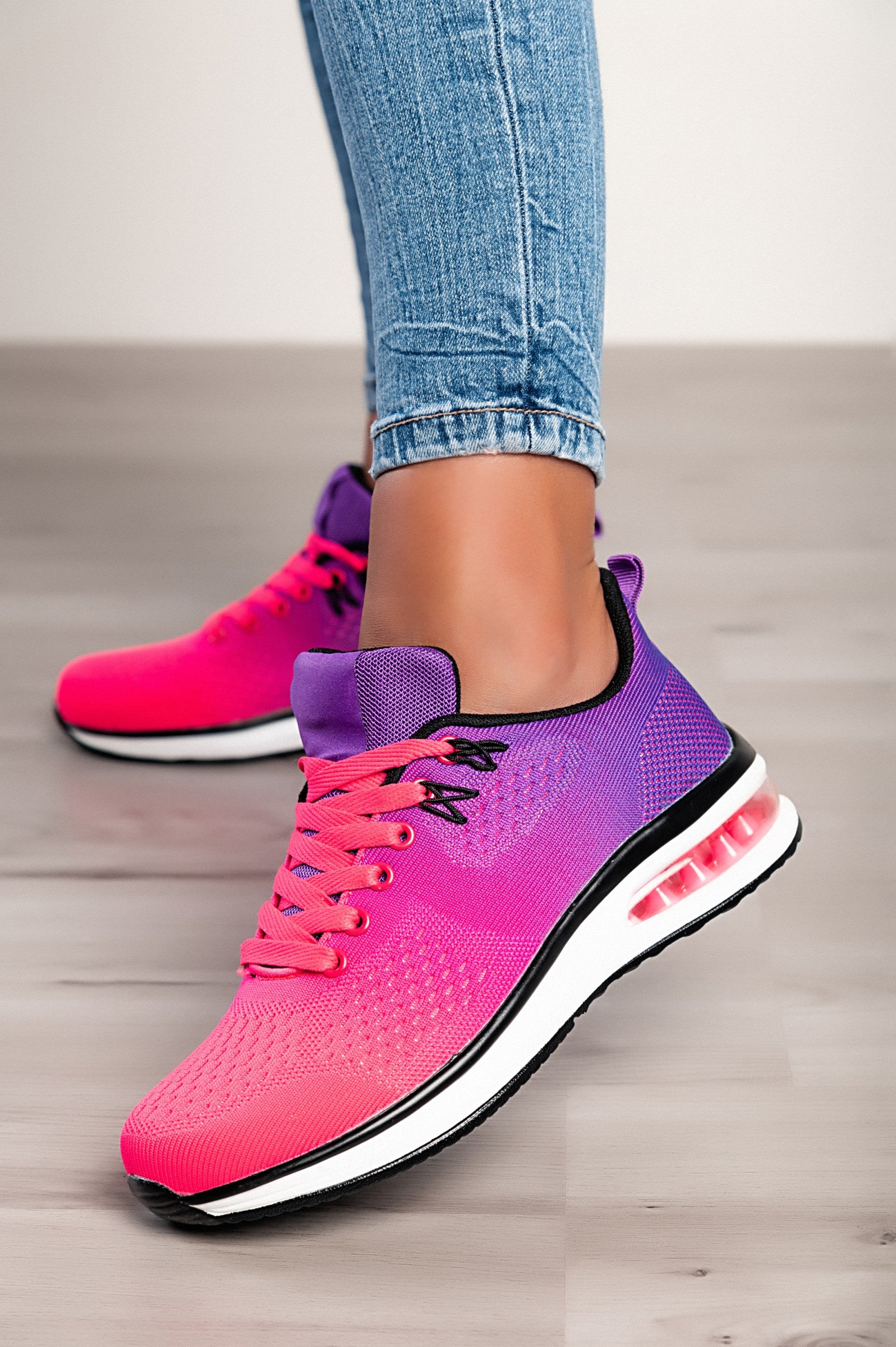 Stylish two-tone purple sneakers with a textile upper, reinforced heel and toe, and lace-up closure.