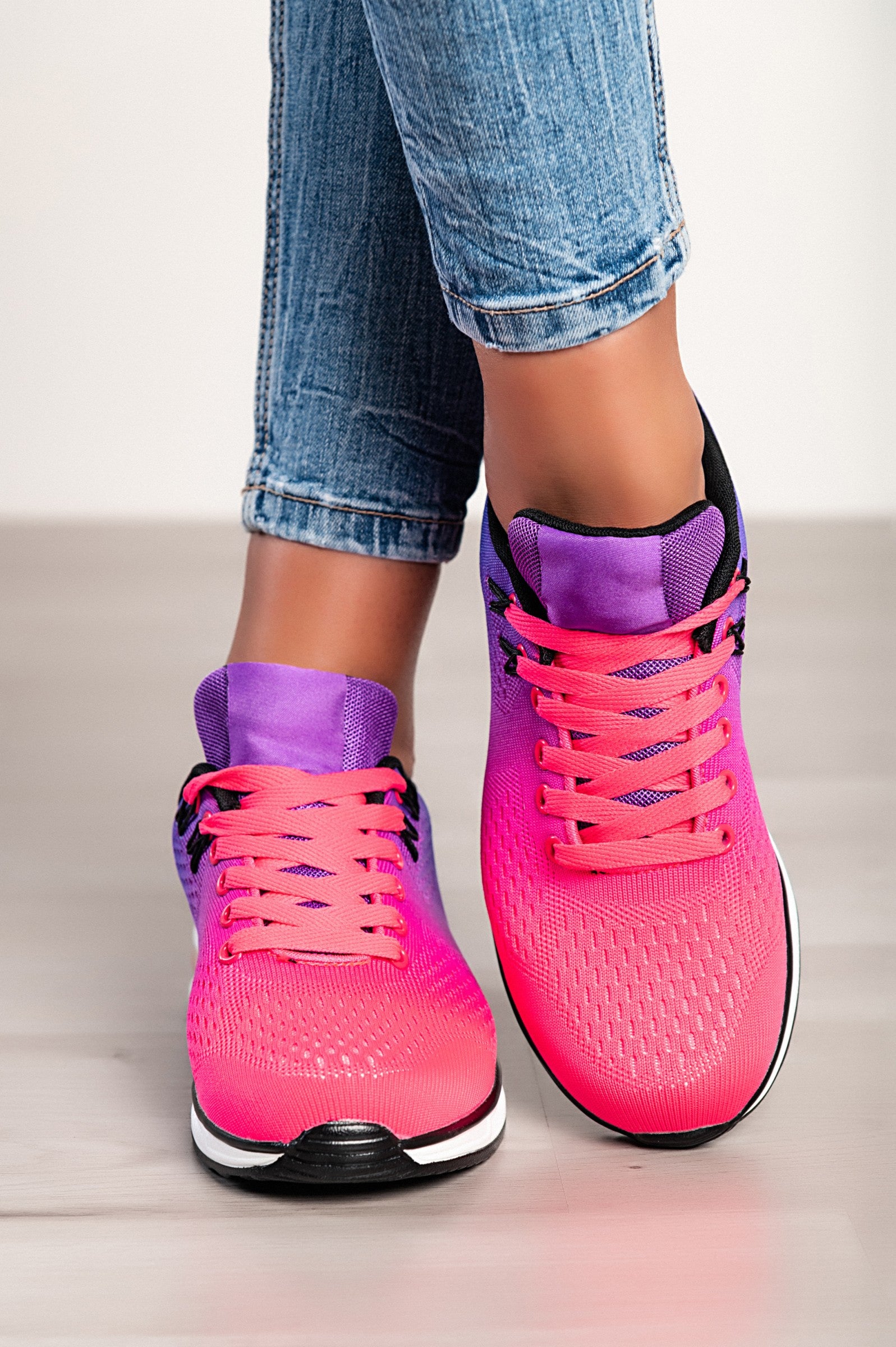 Stylish two-tone purple sneakers with a textile upper, reinforced heel and toe, and lace-up closure.