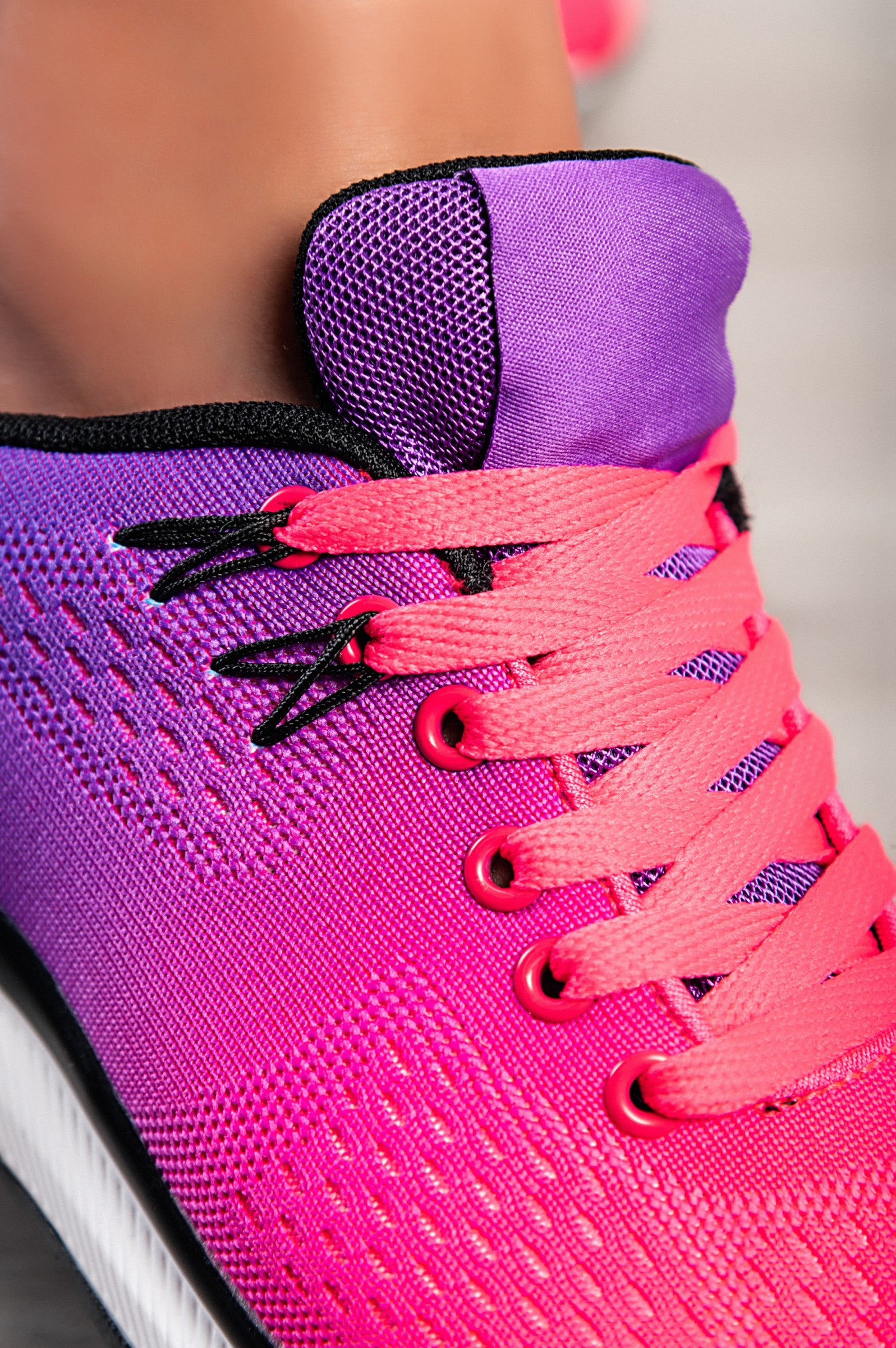 Stylish two-tone purple sneakers with a textile upper, reinforced heel and toe, and lace-up closure.