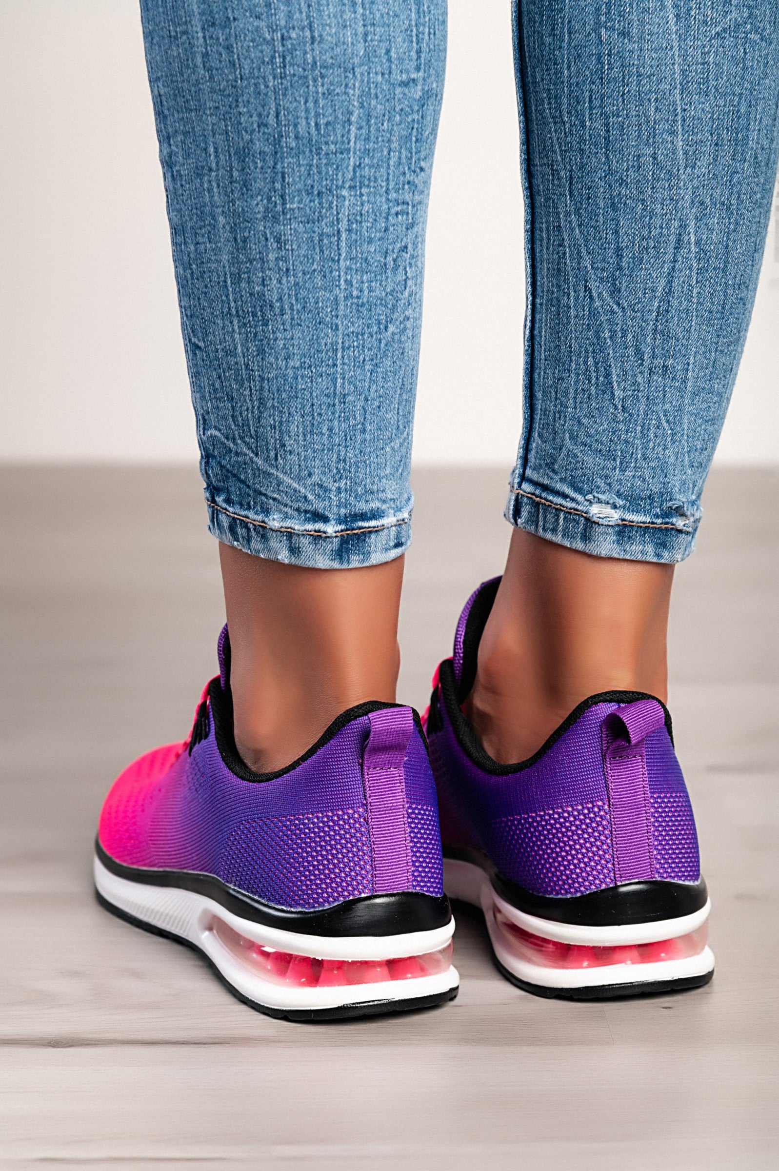 Stylish two-tone purple sneakers with a textile upper, reinforced heel and toe, and lace-up closure.