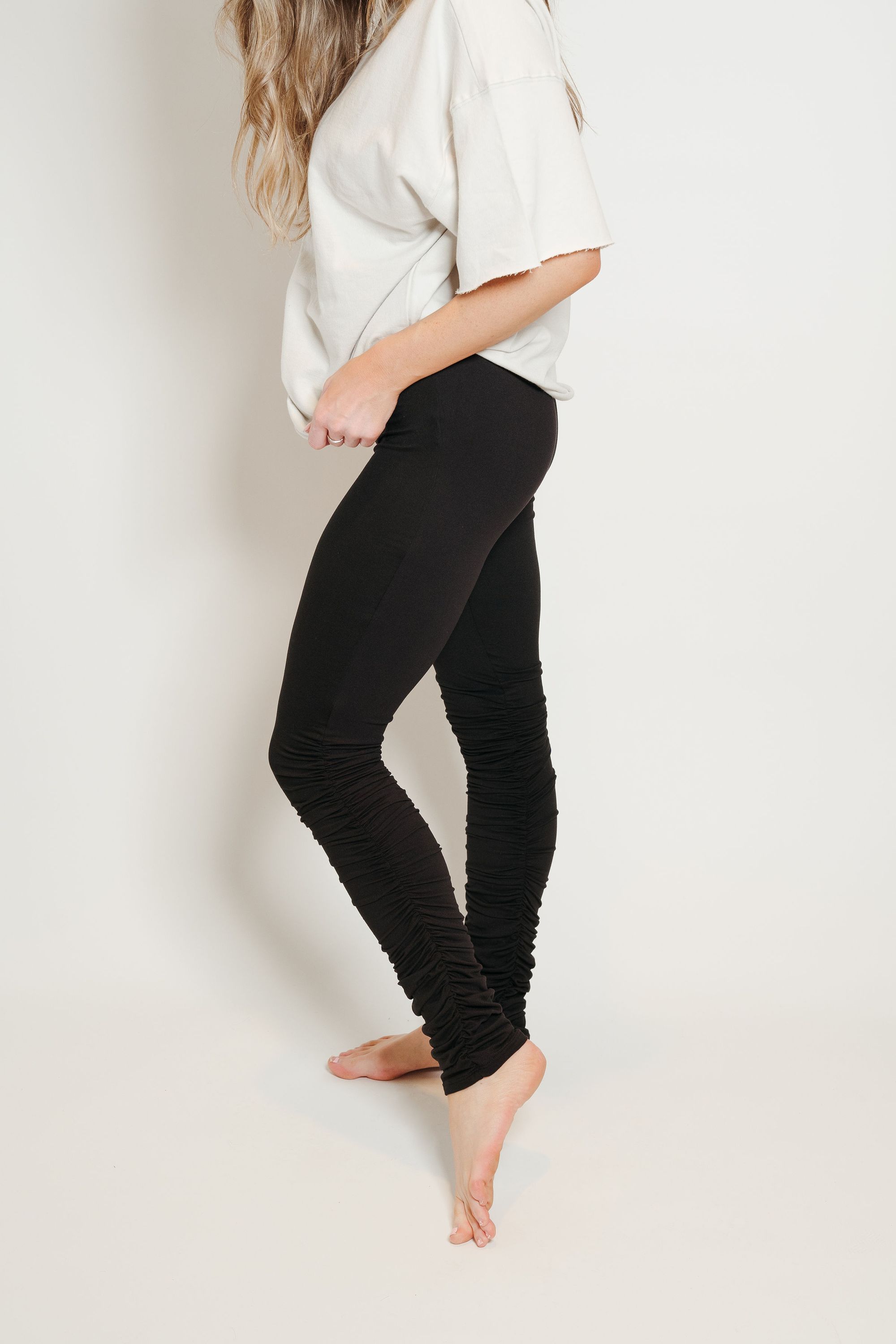 A pair of ultra soft black stacked leggings featuring ruffled bottoms and a stretchy waistband, perfect for comfort and style.