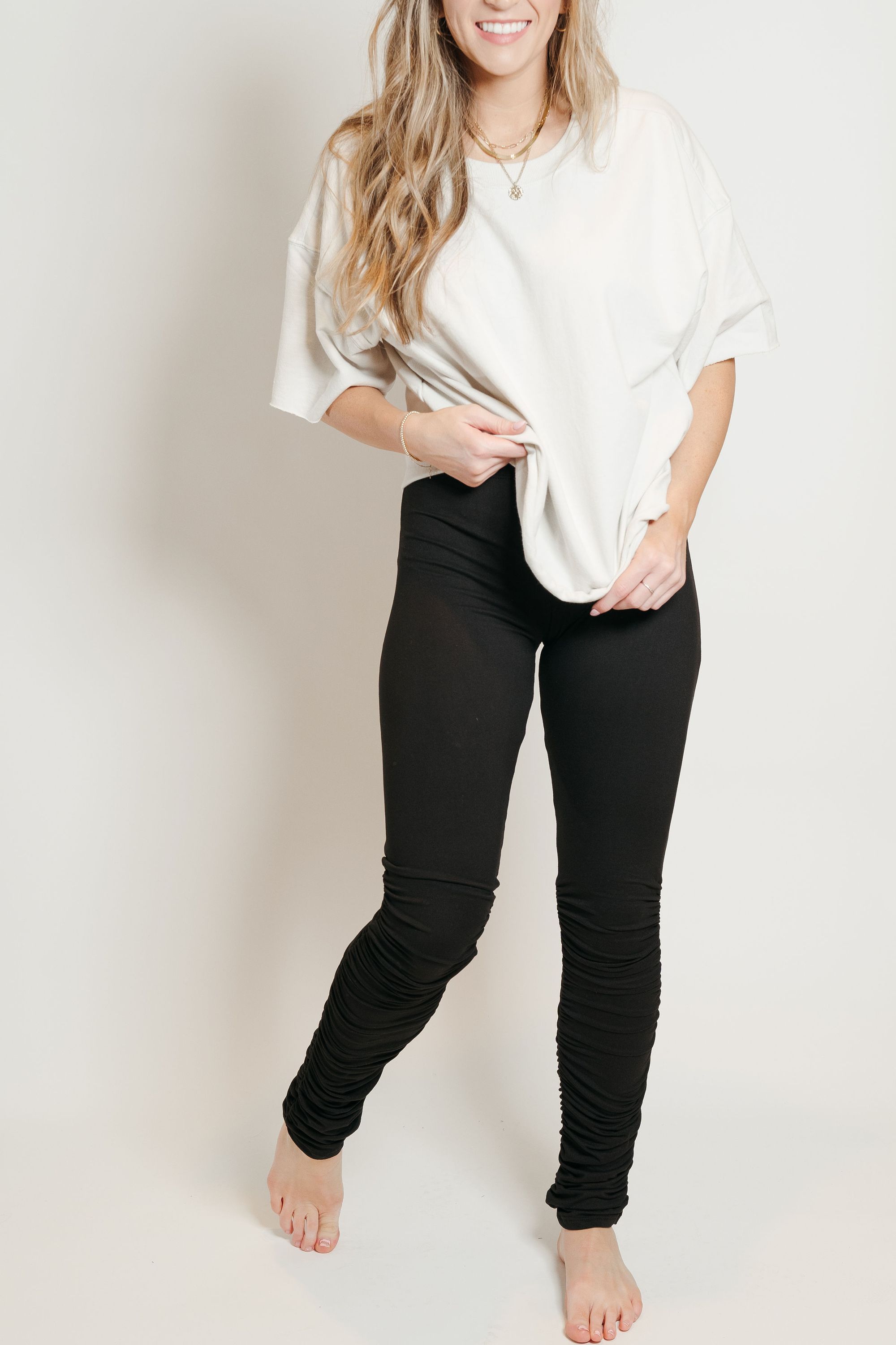 A pair of ultra soft black stacked leggings featuring ruffled bottoms and a stretchy waistband, perfect for comfort and style.