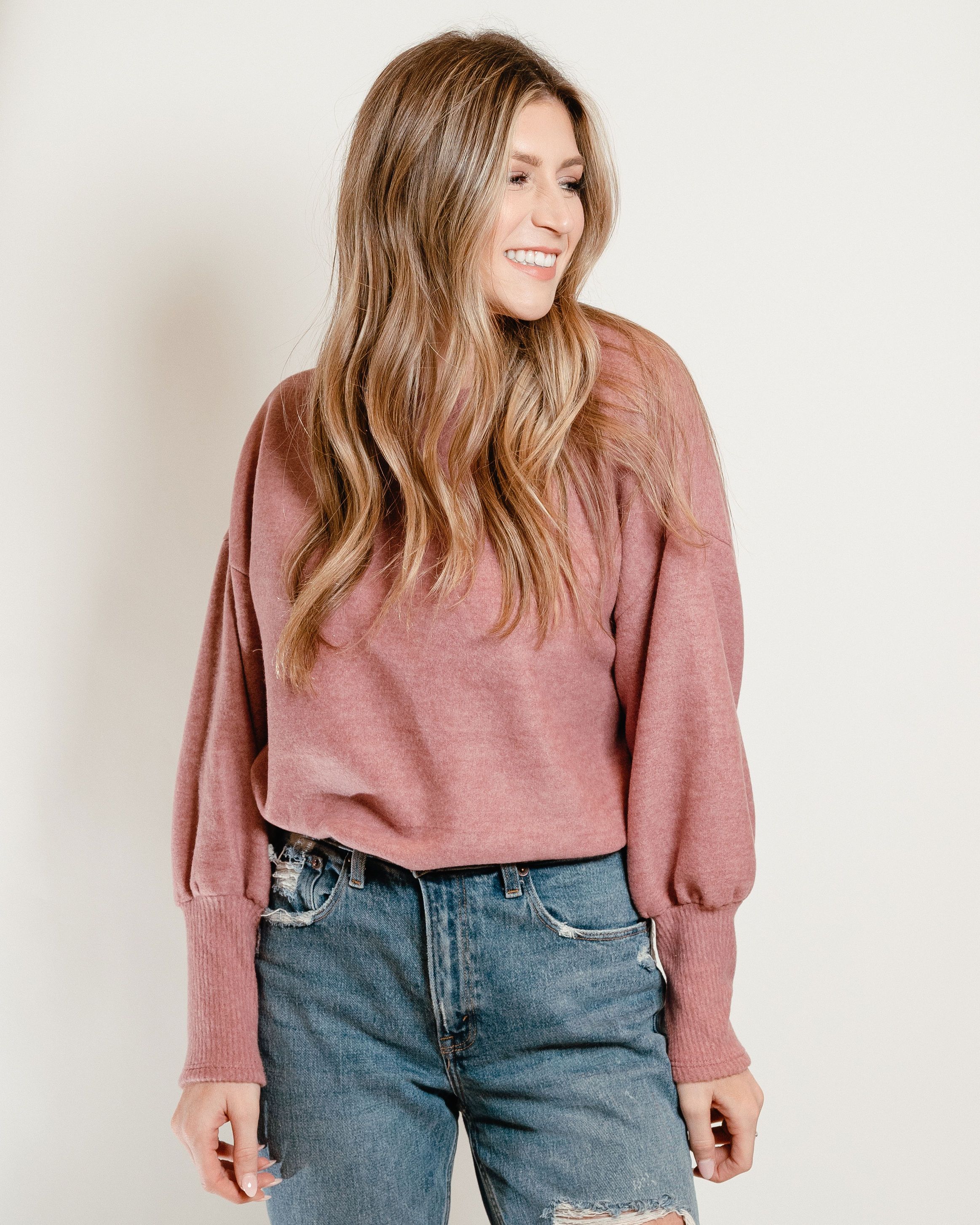 A cozy Ultra Soft Sweater in Deep Rose with billowing sleeves and ribbed cuffs, perfect for spring layering.