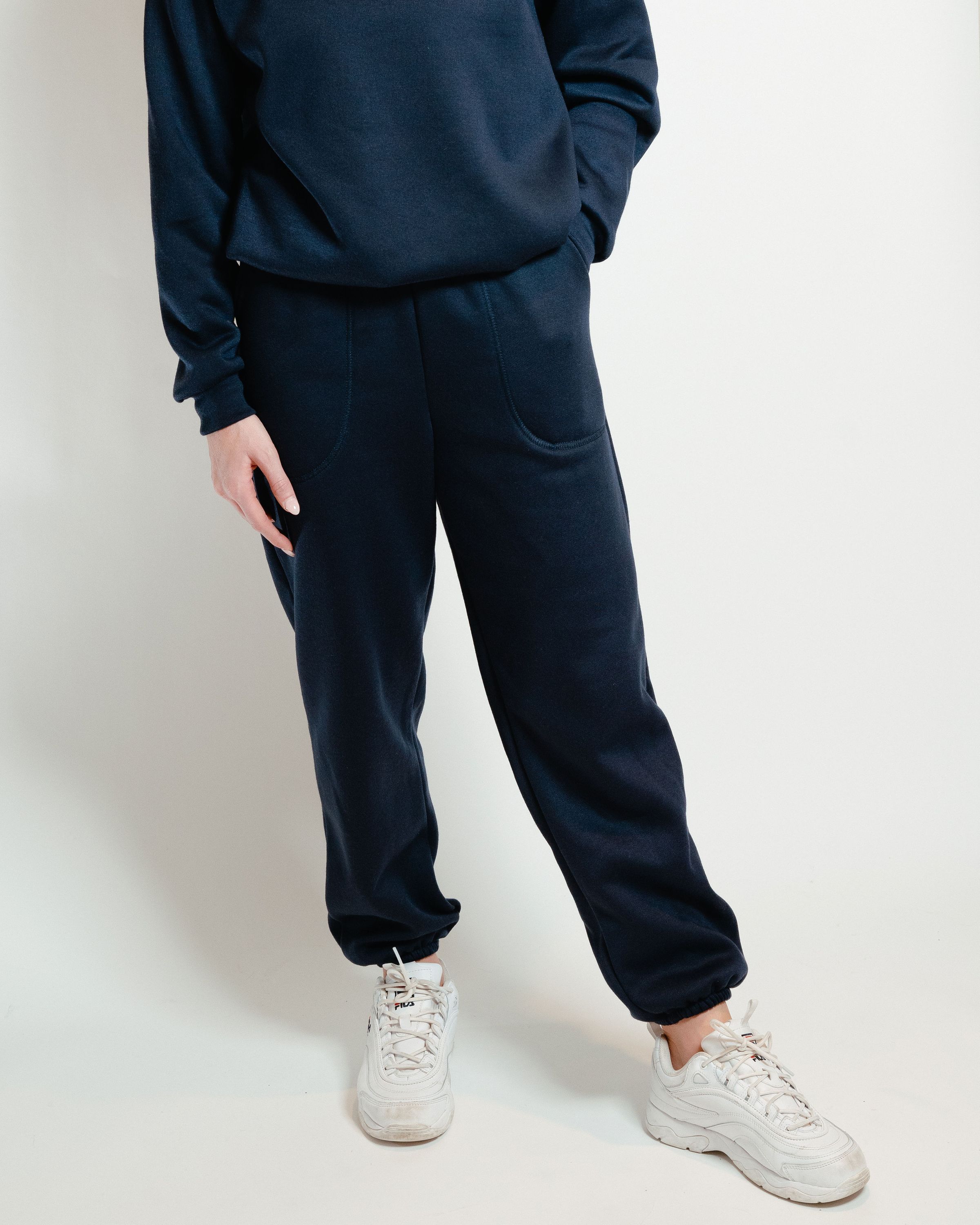 A pair of navy unisex sweatpants featuring a soft interior, perfect for lounging or casual outings.