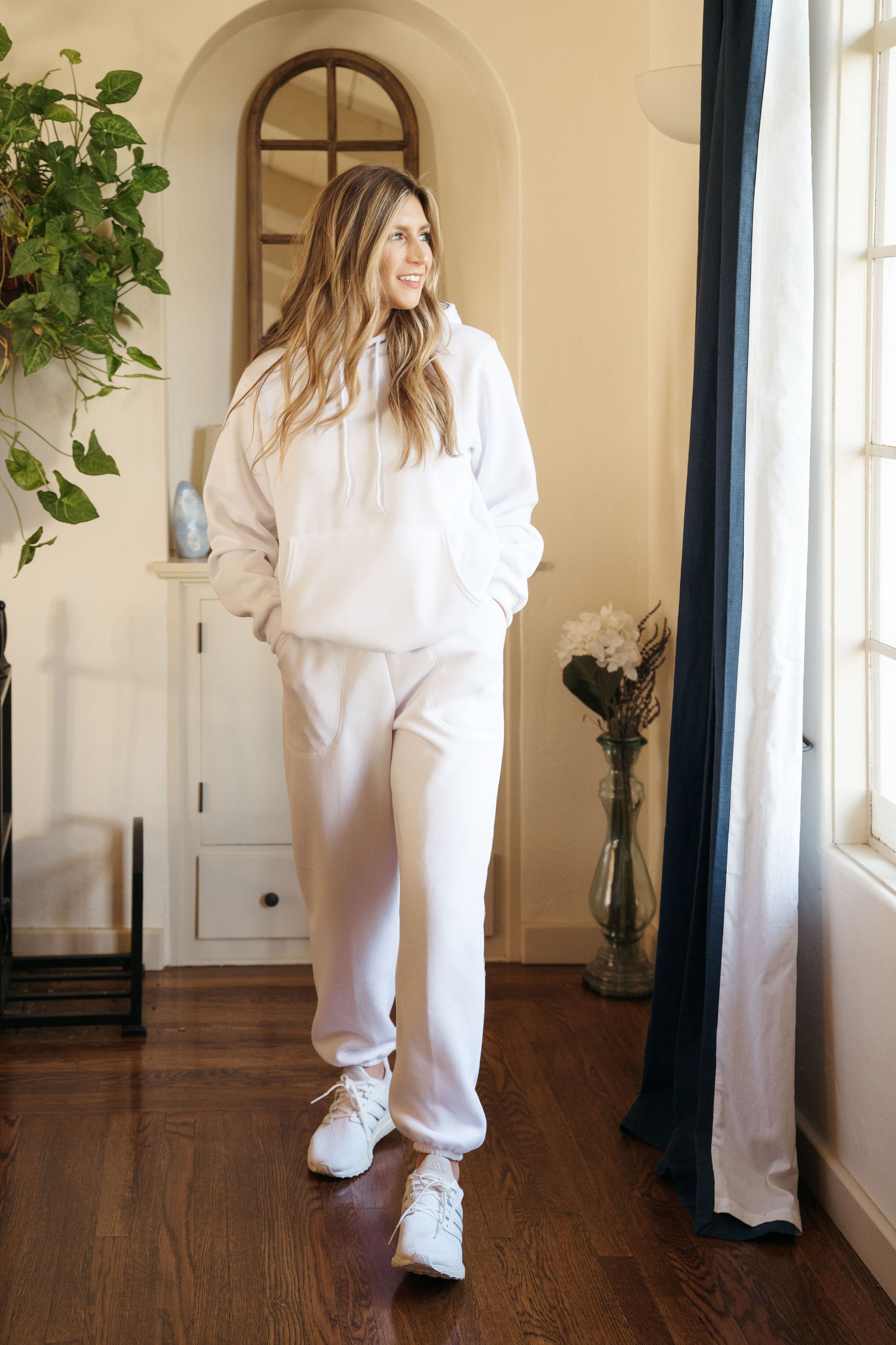 A pair of white unisex sweatpants displayed on a neutral background, showcasing their soft fabric and gender-neutral design.