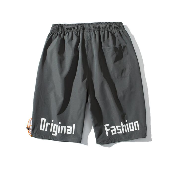 US Stock Men's Tooling Shorts in a casual outdoor setting, showcasing the breathable polyester material and drawstring closure.