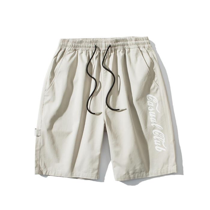 US Stock Men's Tooling Shorts in a casual outdoor setting, showcasing the breathable polyester material and drawstring closure.