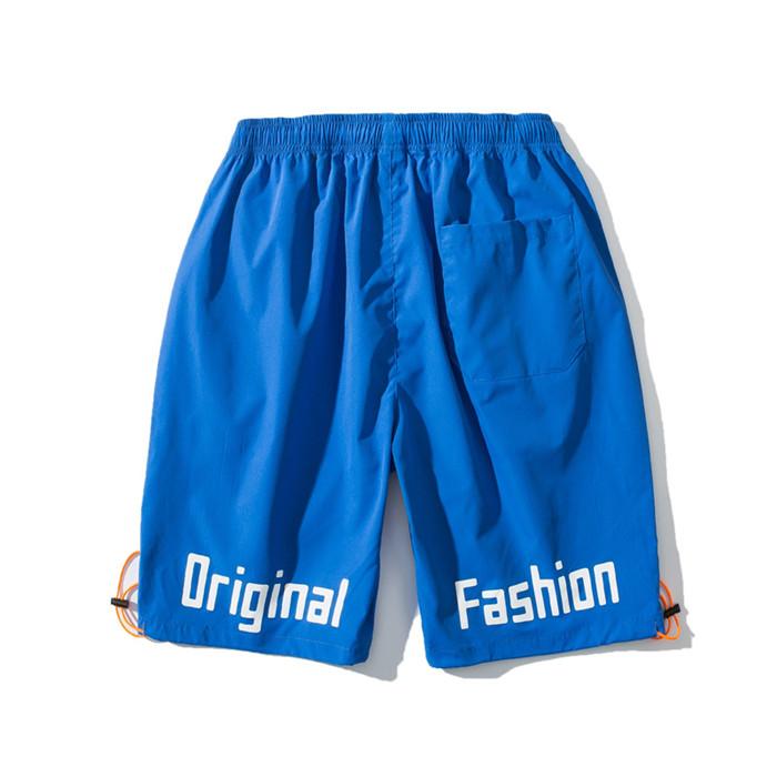 US Stock Men's Tooling Shorts in a casual outdoor setting, showcasing the breathable polyester material and drawstring closure.