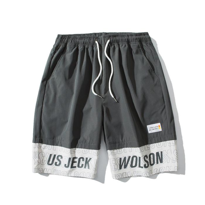 US Stock Men's Tooling Shorts in a casual outdoor setting, showcasing the breathable polyester material and drawstring closure.