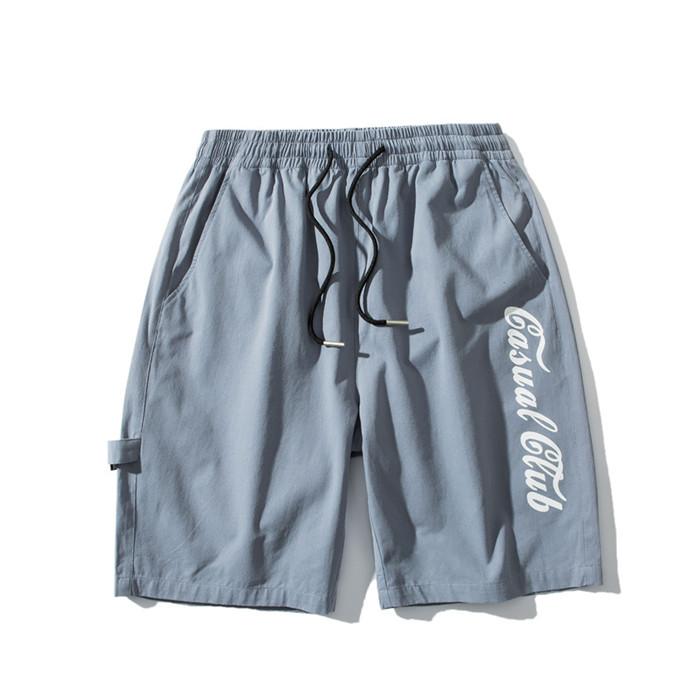 US Stock Men's Tooling Shorts in a casual outdoor setting, showcasing the breathable polyester material and drawstring closure.