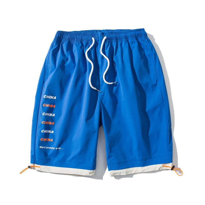 US Stock Men's Tooling Shorts in a casual outdoor setting, showcasing the breathable polyester material and drawstring closure.