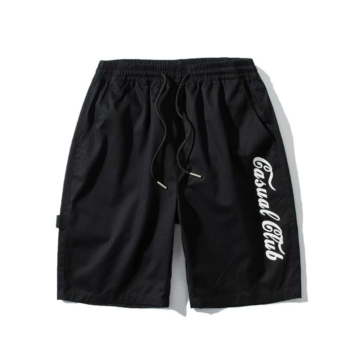 US Stock Men's Tooling Shorts in a casual outdoor setting, showcasing the breathable polyester material and drawstring closure.