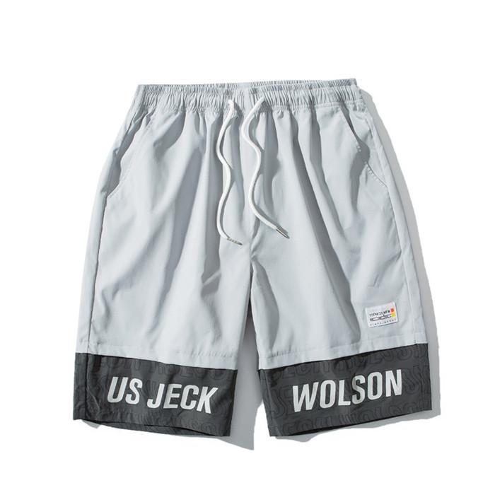 US Stock Men's Tooling Shorts in a casual outdoor setting, showcasing the breathable polyester material and drawstring closure.