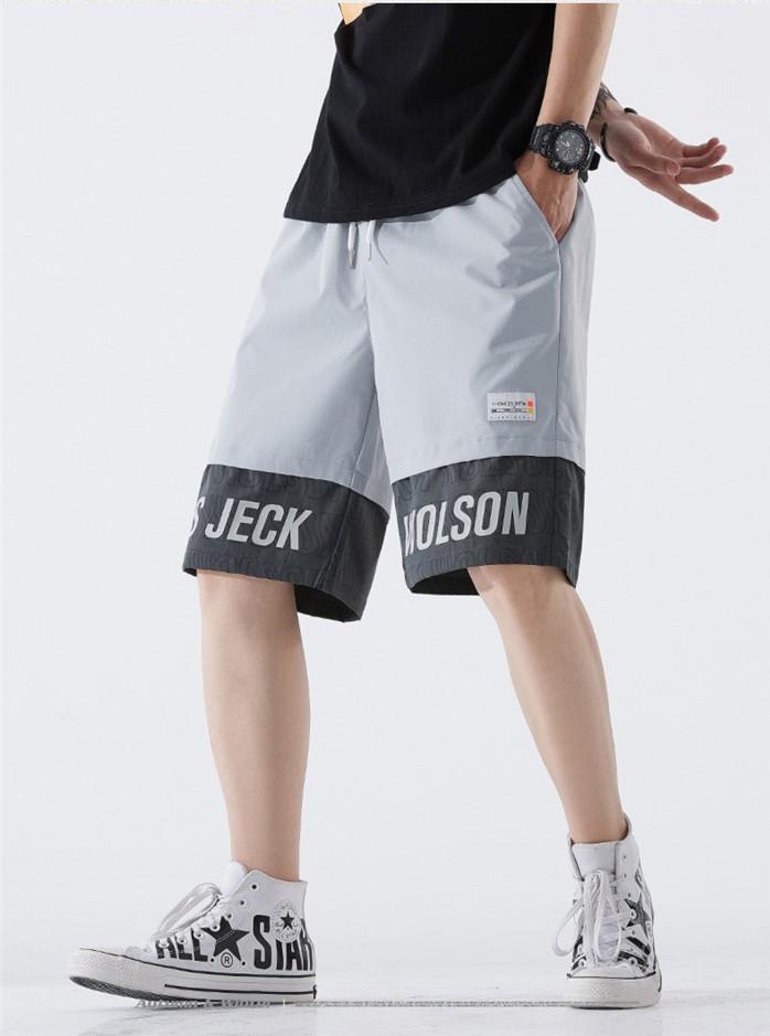 US Stock Men's Tooling Shorts in a casual outdoor setting, showcasing the breathable polyester material and drawstring closure.