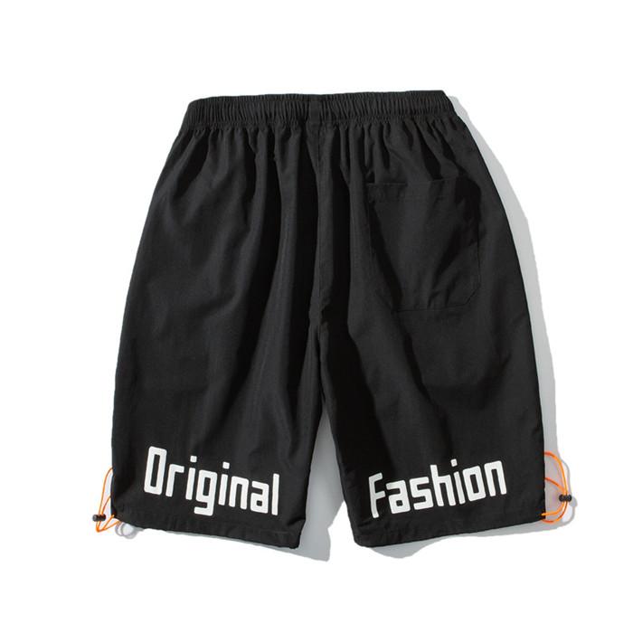 US Stock Men's Tooling Shorts in a casual outdoor setting, showcasing the breathable polyester material and drawstring closure.