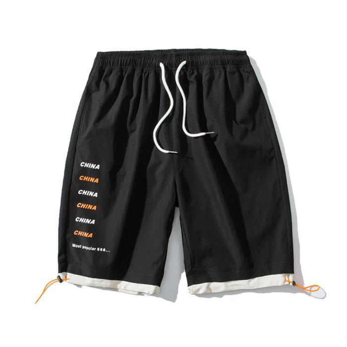 US Stock Men's Tooling Shorts in a casual outdoor setting, showcasing the breathable polyester material and drawstring closure.