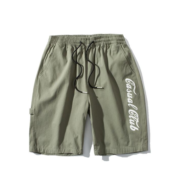 US Stock Men's Tooling Shorts in a casual outdoor setting, showcasing the breathable polyester material and drawstring closure.