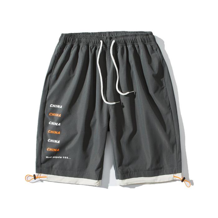 US Stock Men's Tooling Shorts in a casual outdoor setting, showcasing the breathable polyester material and drawstring closure.