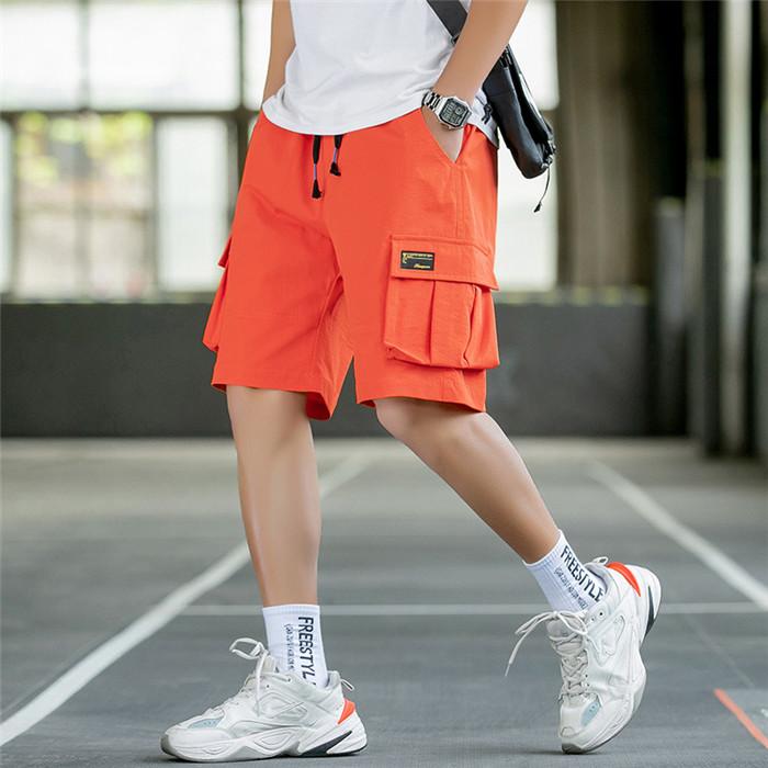 US Stock Men's Tooling Shorts in casual outdoor setting, showcasing drawstring closure and lightweight polyester material.