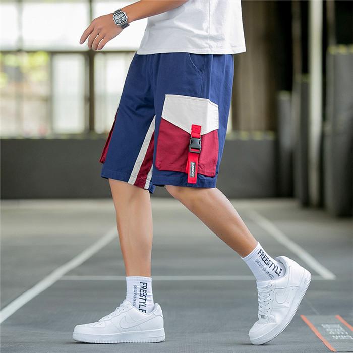 US Stock Men's Tooling Shorts in casual outdoor setting, showcasing drawstring closure and lightweight polyester material.