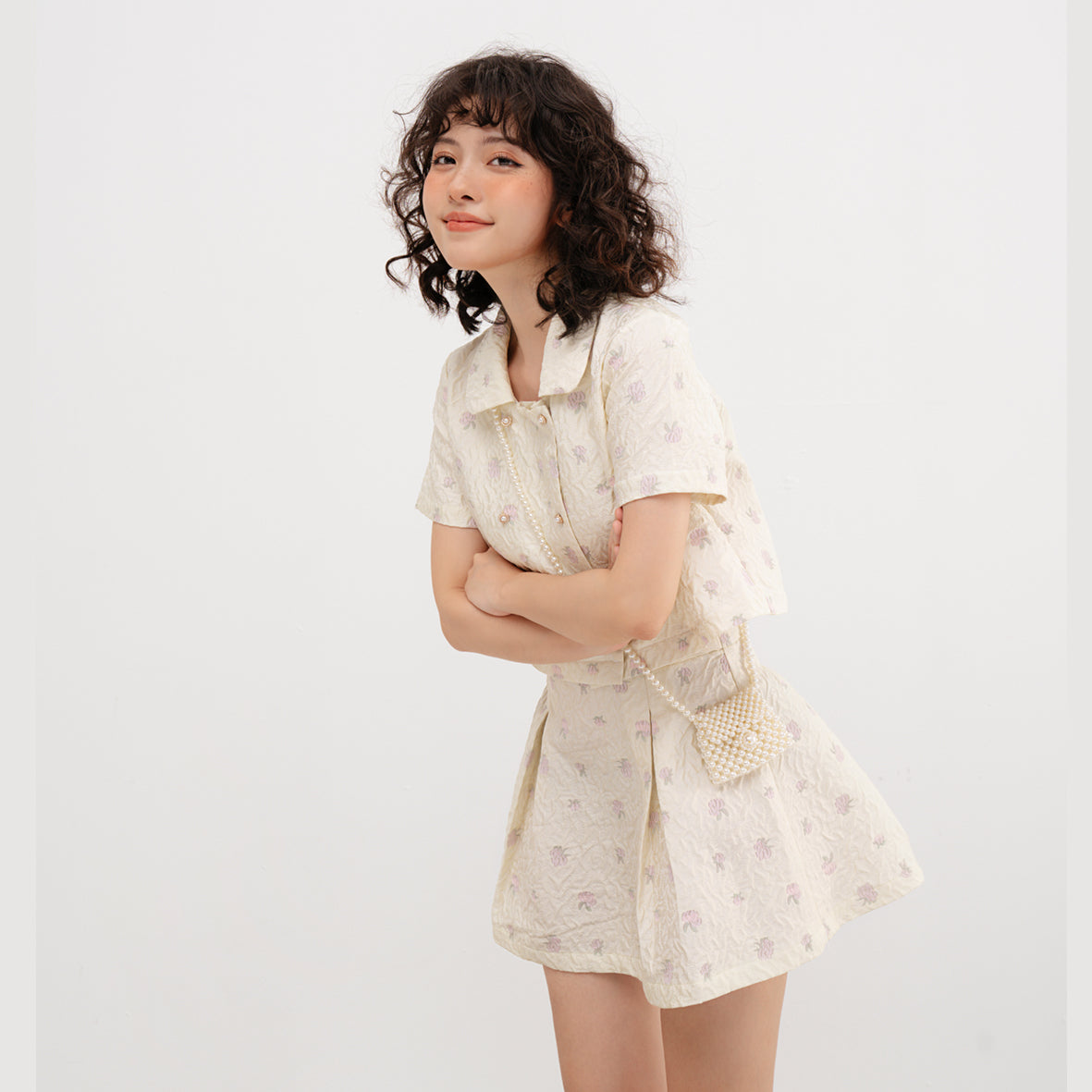 Usagi Top featuring embroidered brocade fabric with flower buttons and pleated skirt design.