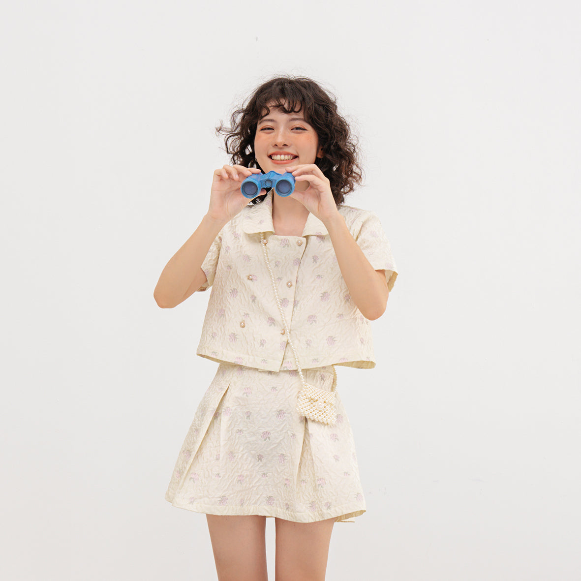 Usagi Top featuring embroidered brocade fabric with flower buttons and pleated skirt design.