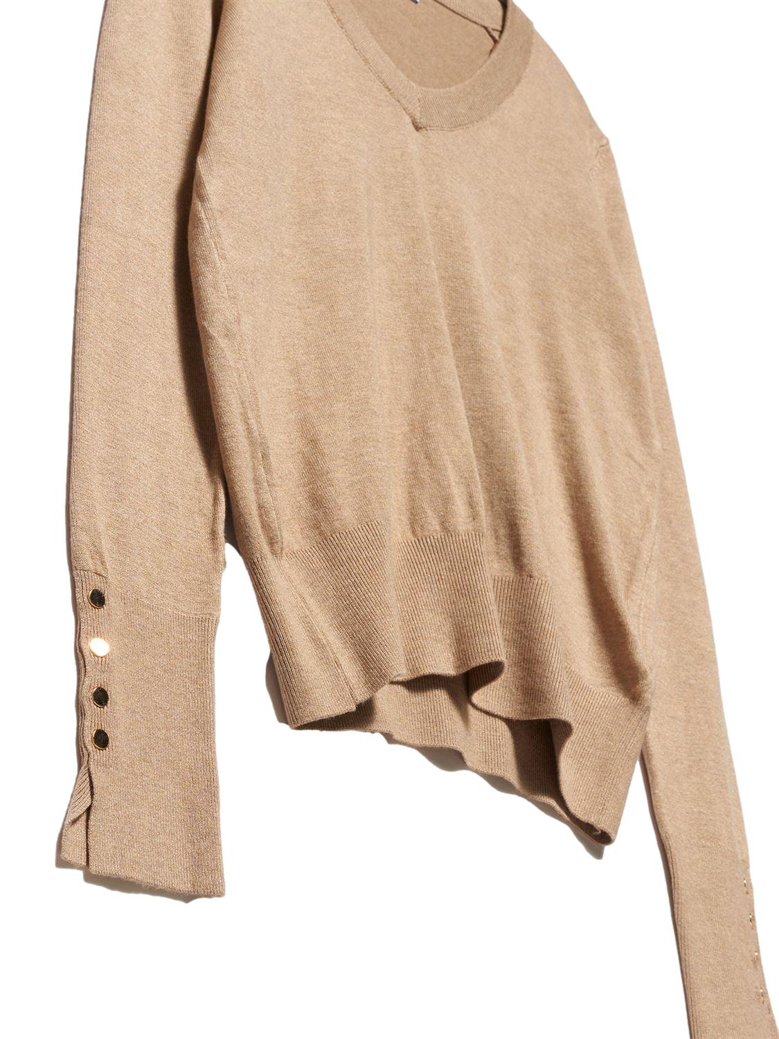 A stylish V Neck Cuff Dropped Sweater in soft fabric, showcasing a modern dropped cuff design and elegant V neckline.