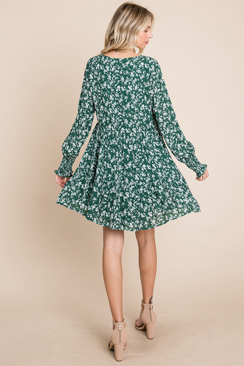 A stylish V neck floral printed long sleeve pleated dress, featuring smocked sleeves and a mini length, perfect for various occasions.