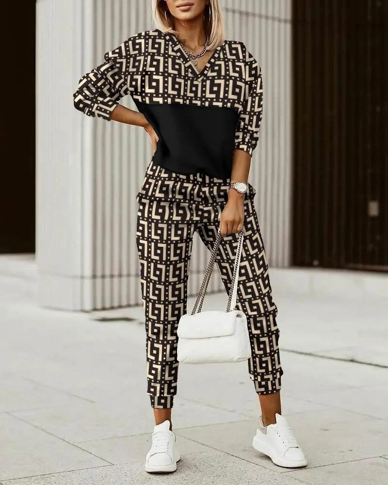 Woman wearing patterned jumpsuit, white shoes.