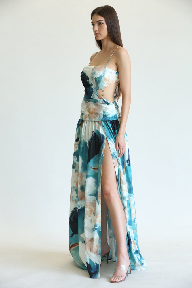 A stylish woman wearing the Verity Watercolor Floral Print Pattern Dress featuring a square neckline, waist cutout, and front leg slit.