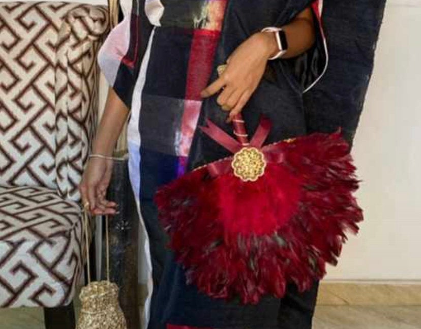 A very unique fur feather hand fan designed for African bridal ceremonies, showcasing intricate feather details and elegant craftsmanship.