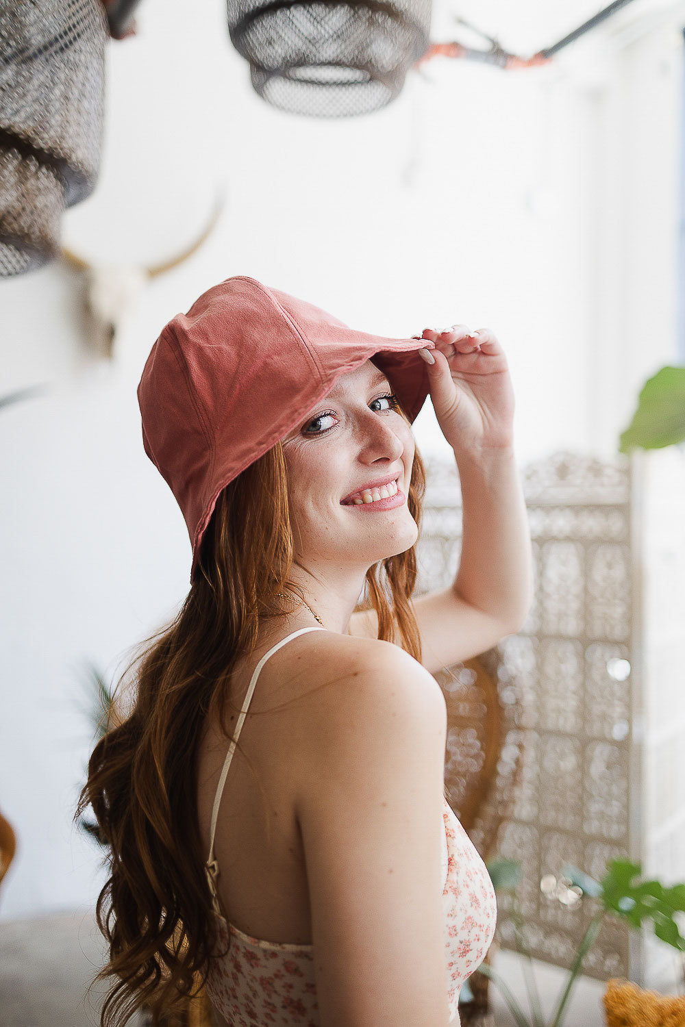 A colorful cotton bucket hat displayed against a bright background, showcasing its vibrant design and adjustable fit.