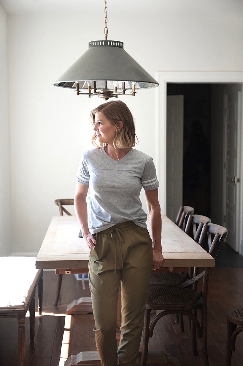 A stylish grey V-neck Game Day Tee displayed on a mannequin, showcasing its sporty design and comfortable fit.