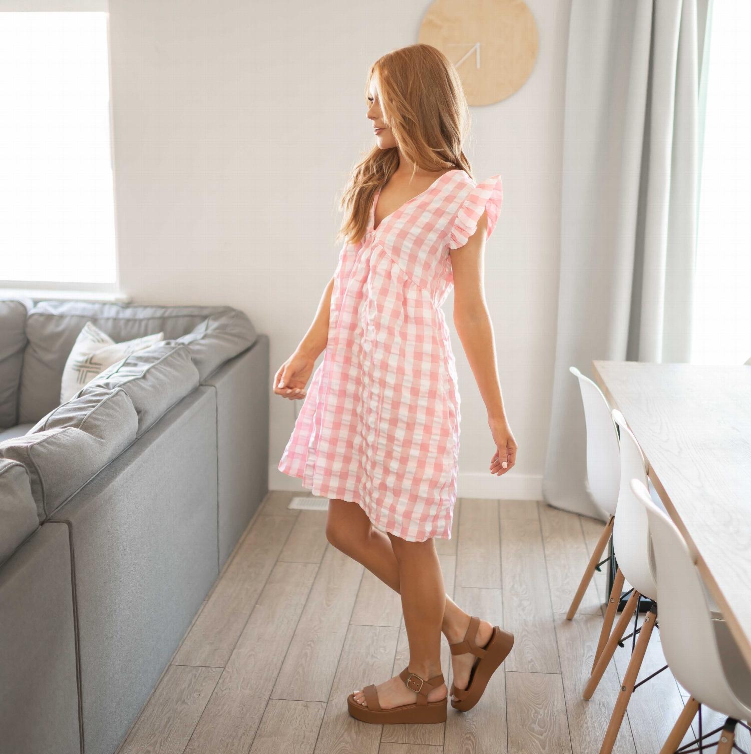 A stylish V-neck Gingham Baby Doll Dress featuring a classic checkered pattern, perfect for casual outings.