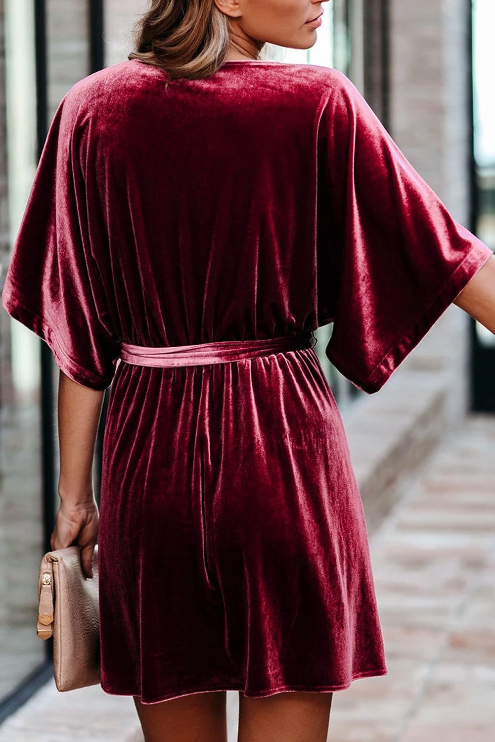 A stylish V-neck half sleeve velvet mini dress with a belt, showcasing its luxurious fabric and elegant design.